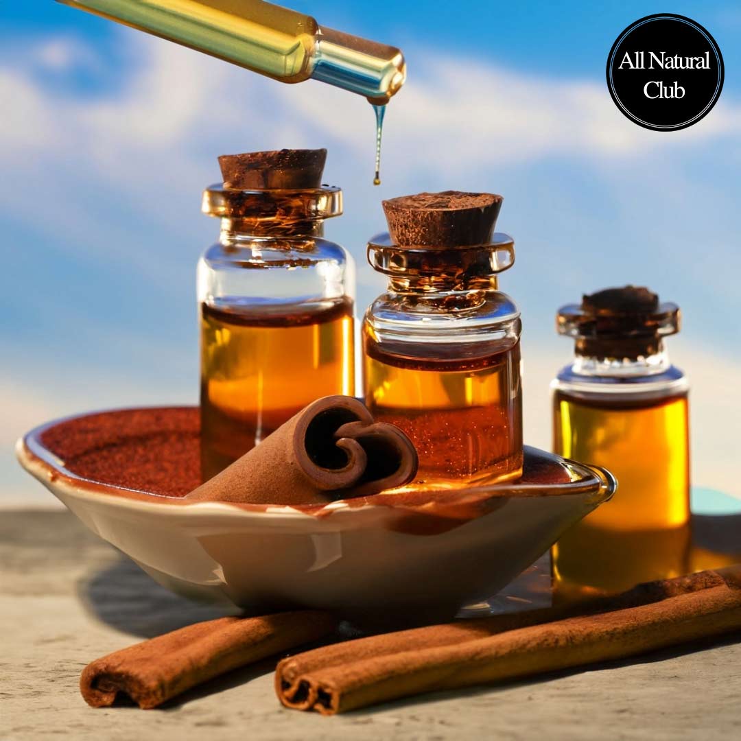 Image of cinnamon oil being poured into small ornate glass jars with cinnamon sticks around and behind the table and with beautiful sky in the background.