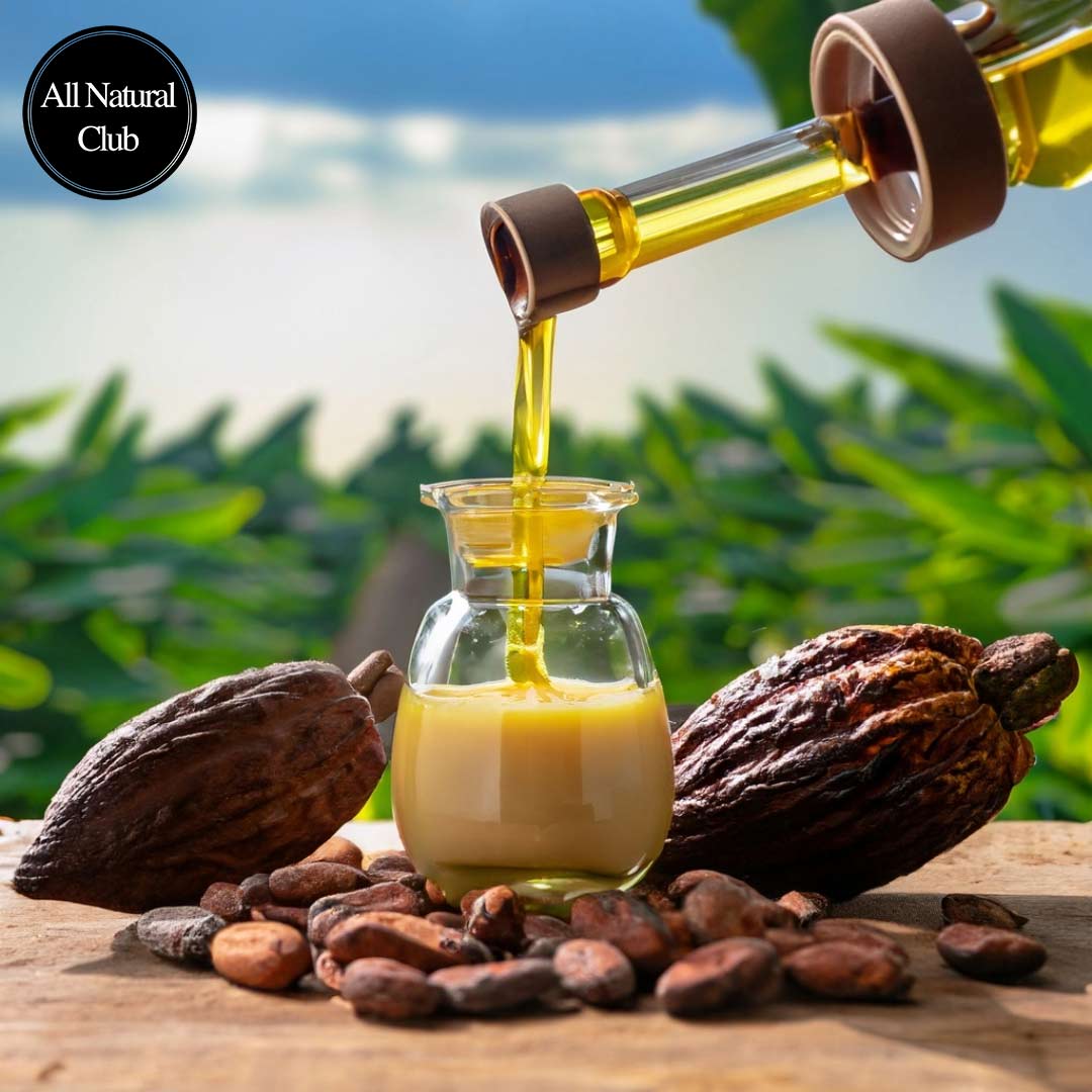 Image of cocoa butter oil being poured into small ornate glass jars with cocoa beans around and behind the table and with beautiful sky and cocoa plants growing in the background.